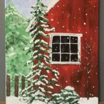 Close up of red barn in snow with a snow covered pine next to it