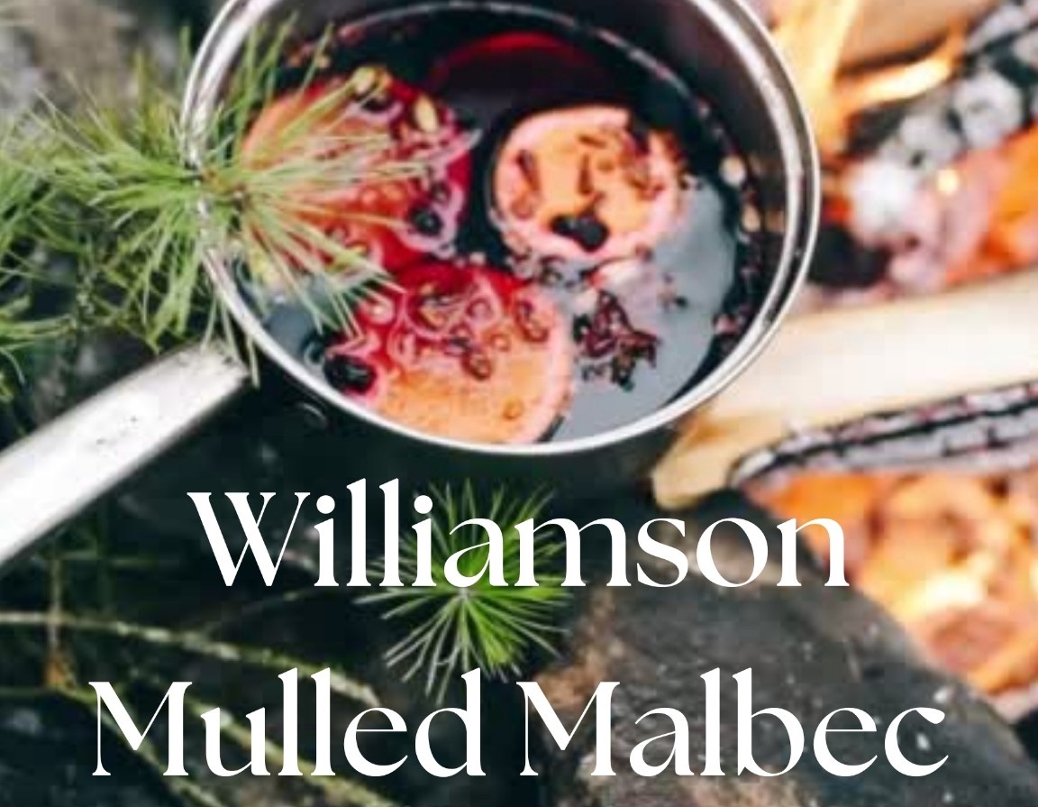 warm wine in cookpot with orange slices and festive accents. Williamson Mulled Malbec